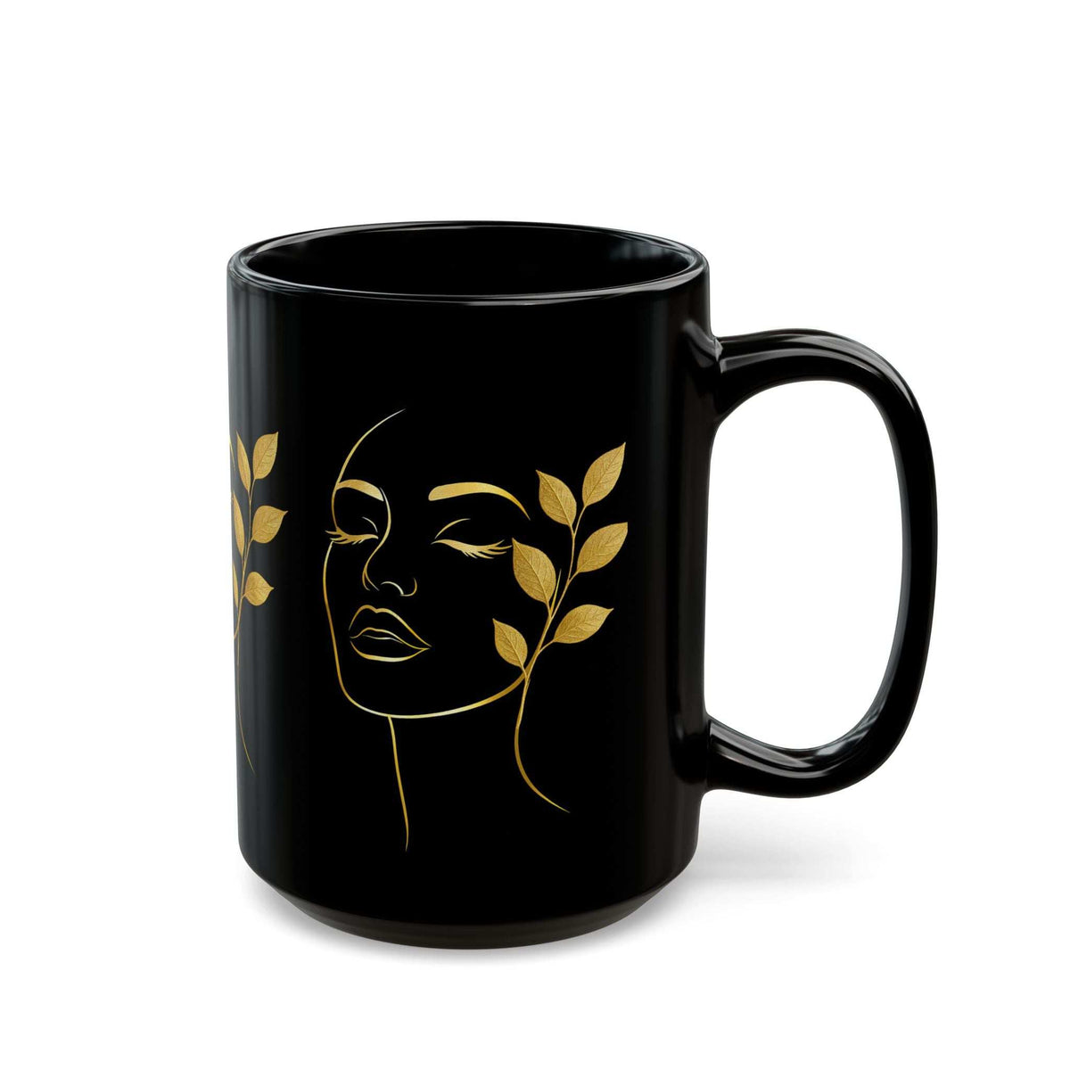 Black ceramic mug with gold face line art and leaf accents, curved handle