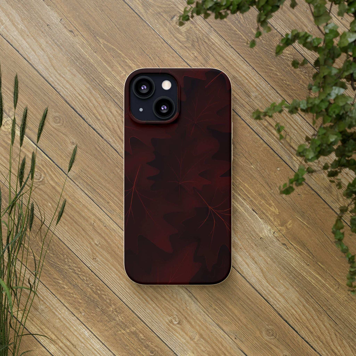 Phone case with dark red leaf pattern and dual camera cutouts, slim profile