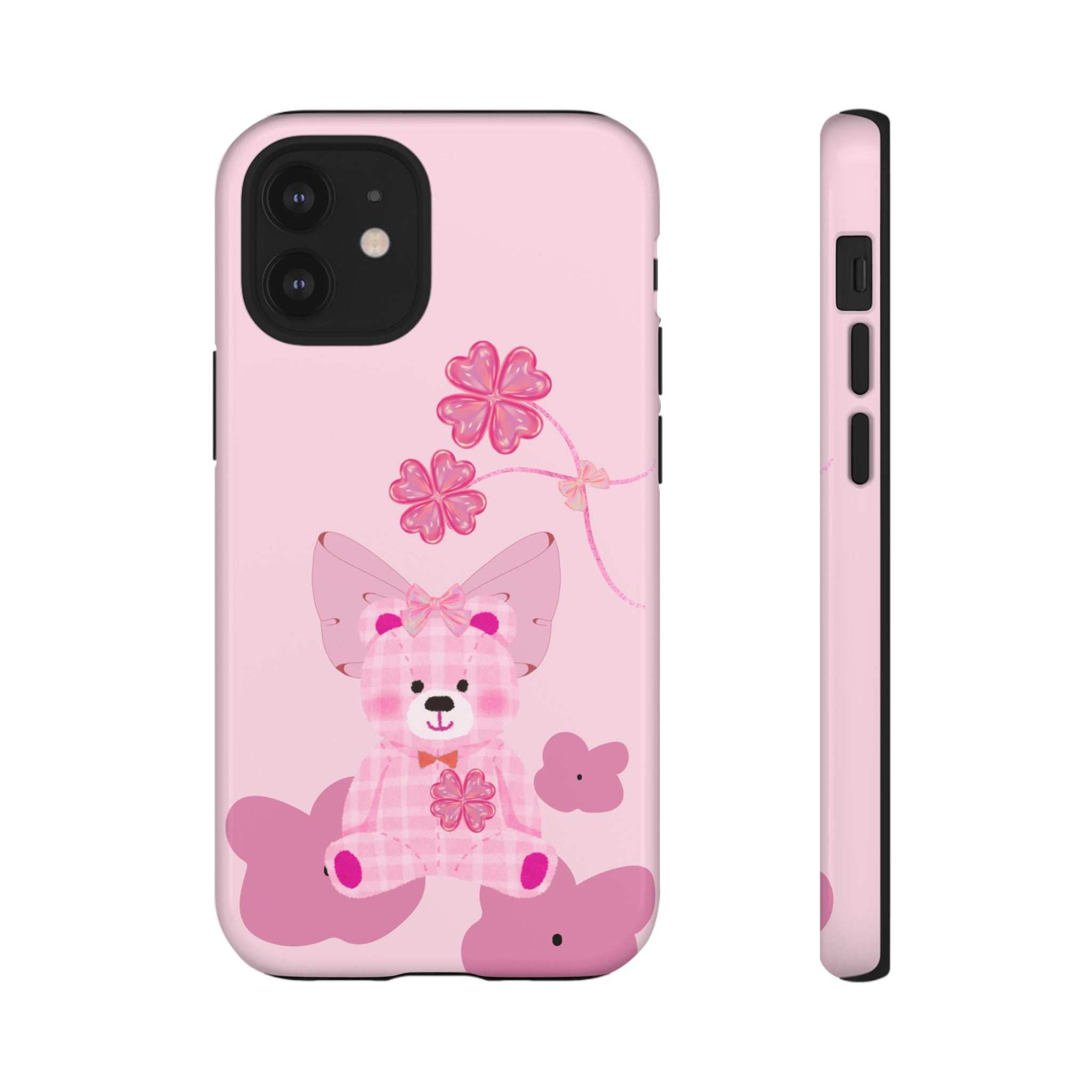 Pink phone case with teddy bear design and floral bow; camera cutout and side edge.