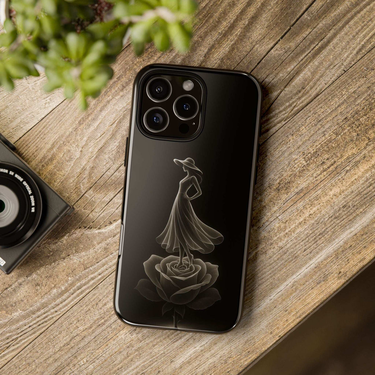 Glossy black phone case with ballet dancer silhouette and rose design, rear camera openings.