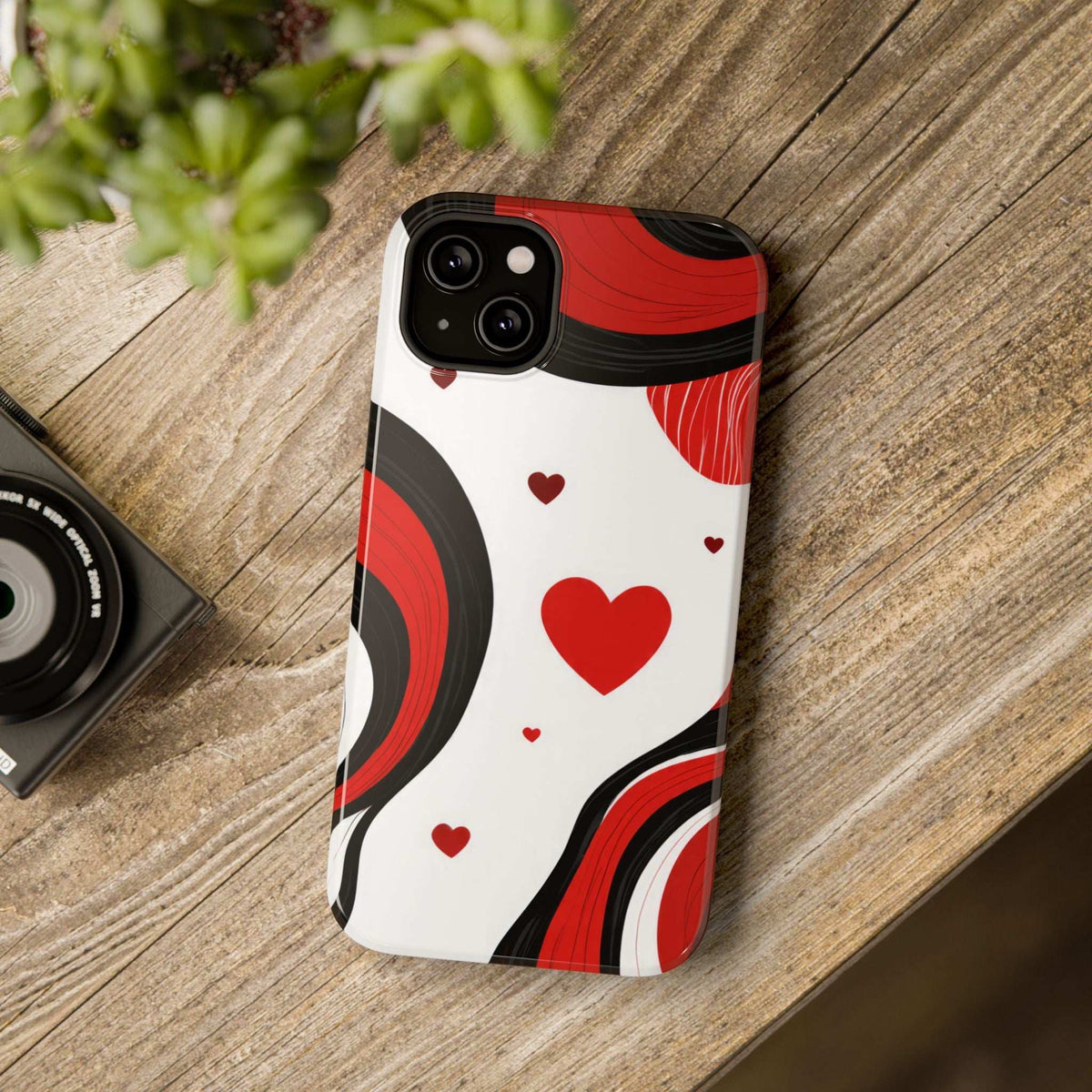 Glossy phone case back view with large red hearts and red swirls on white