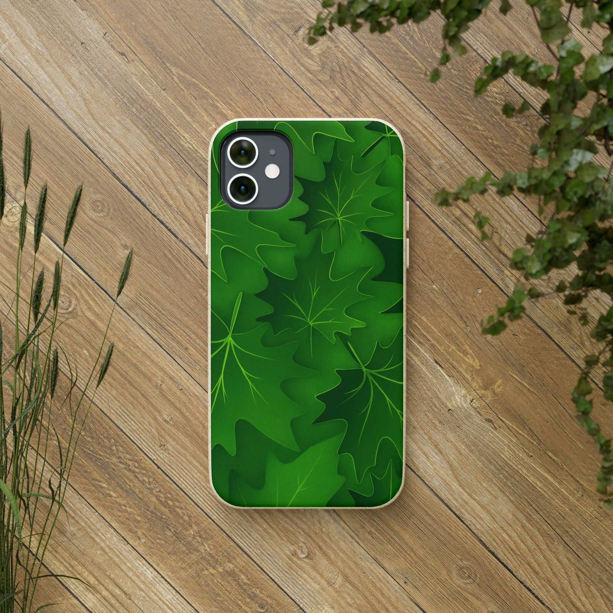 Green botanical leaf phone case with beige speckled edges, back view