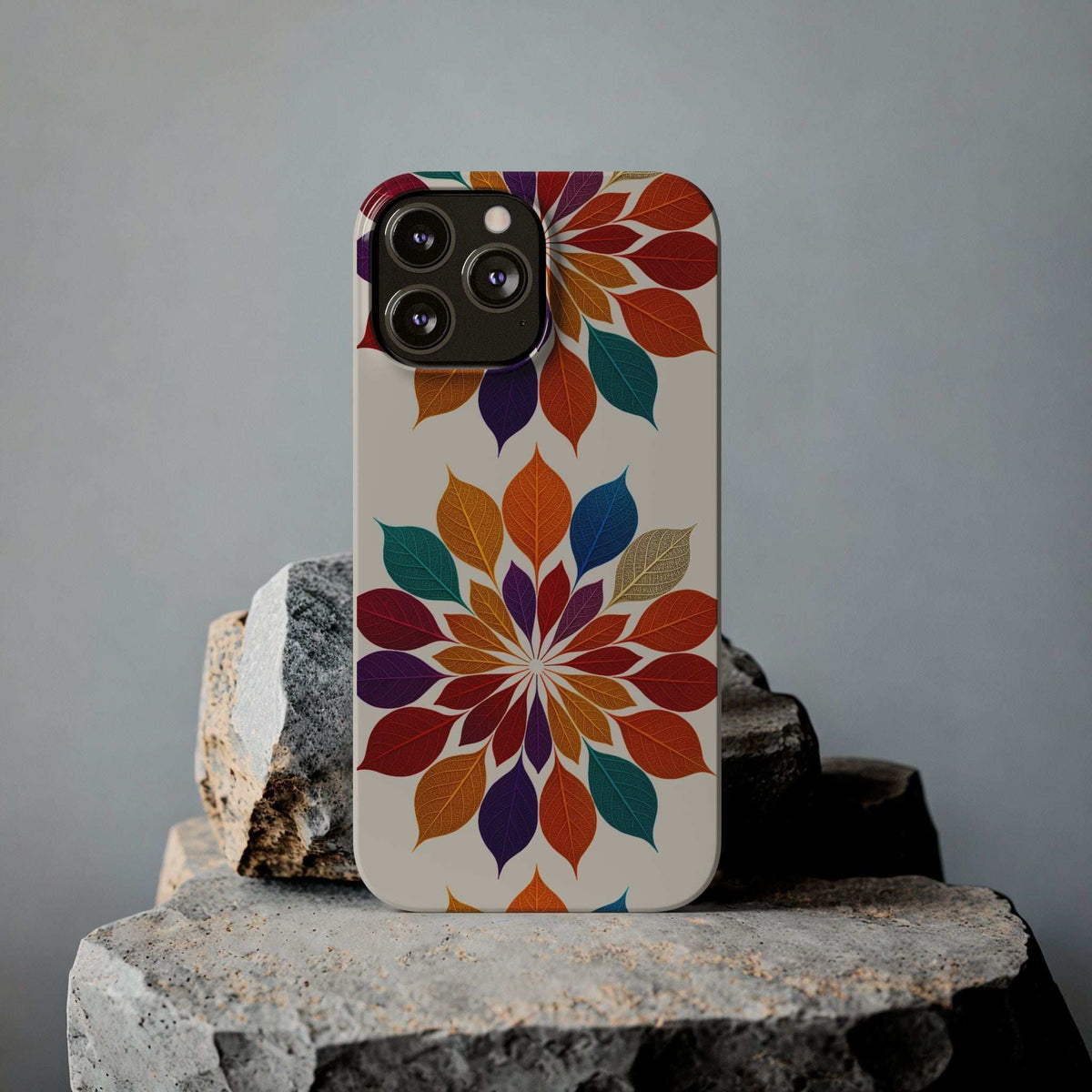 Leaf mandala phone case standing upright with colorful leaf pattern and camera cutouts