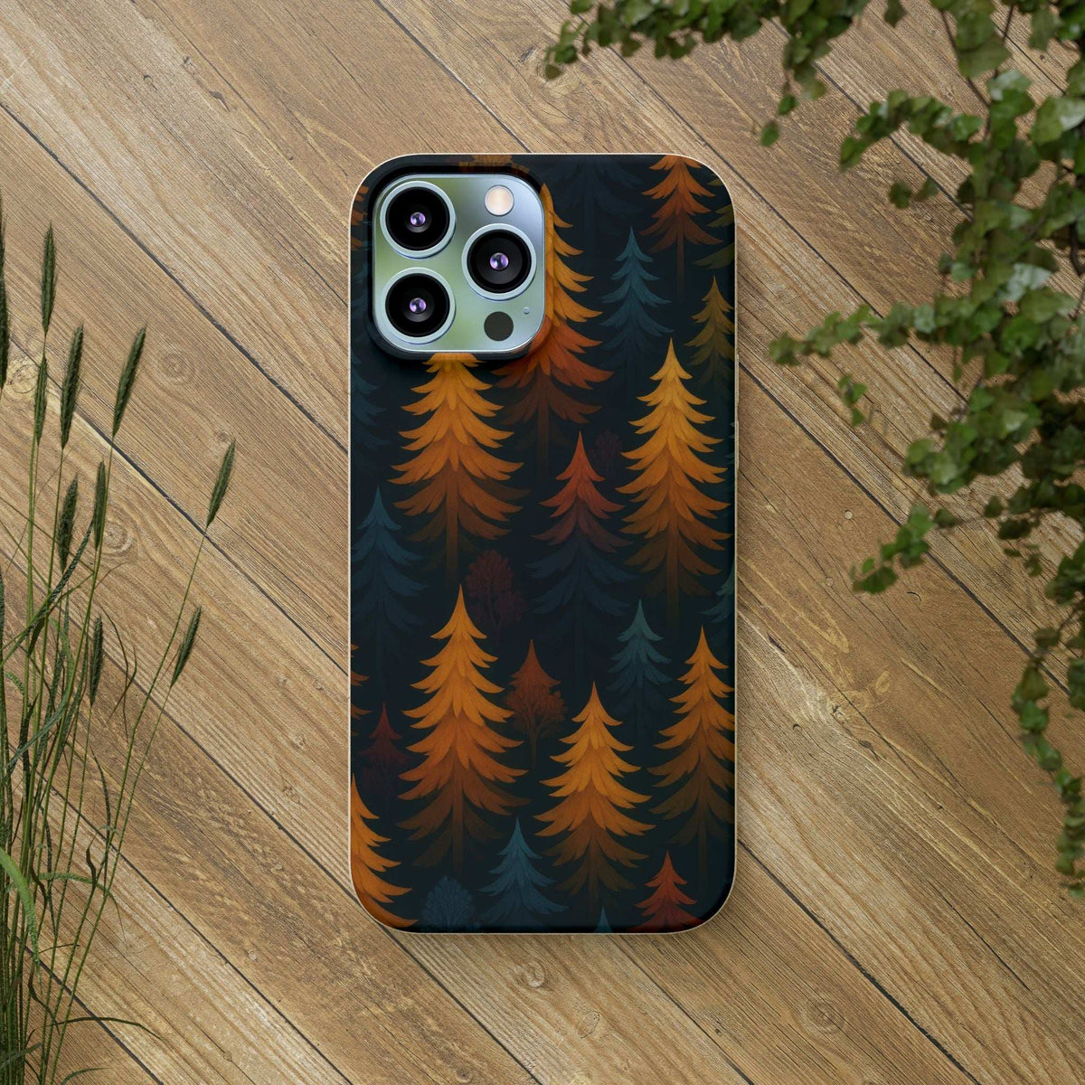 Biodegradable phone case forest tree pattern, dark blue and orange; centered back view