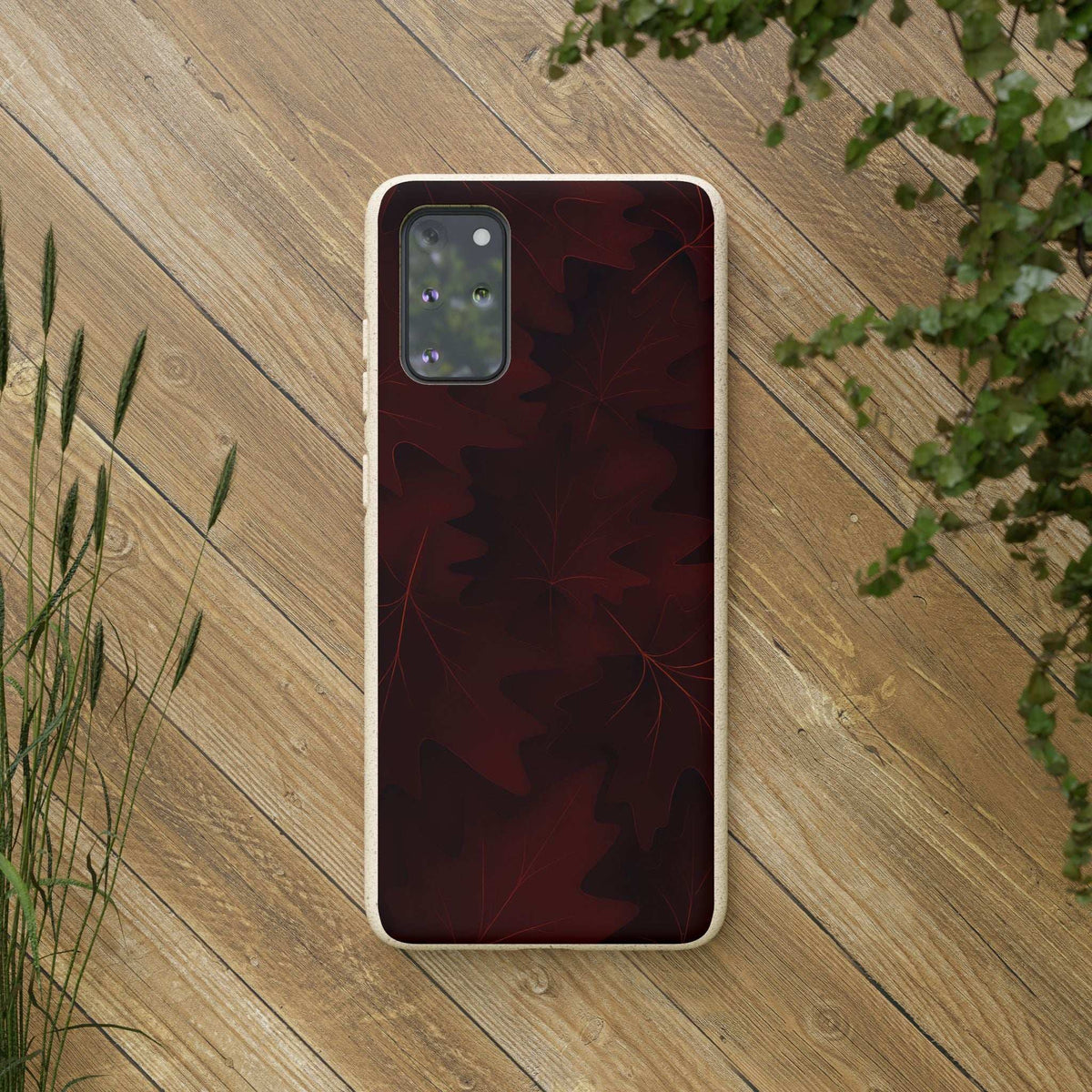 Phone case with burgundy leaf back and beige trim, camera cutout