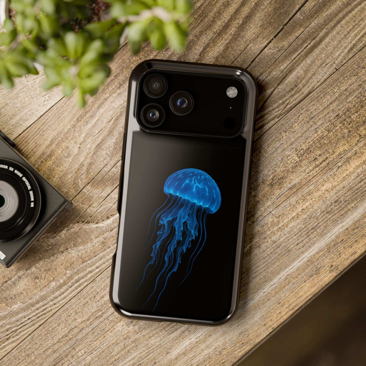 Black phone case with blue jellyfish graphic and exposed camera lens openings.