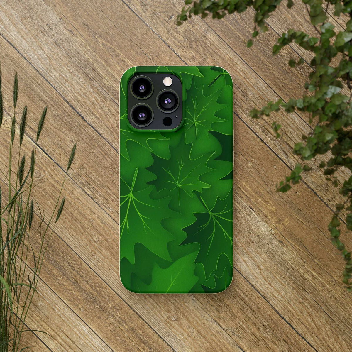 Green leaf phone case on wooden planks, camera module clearly visible