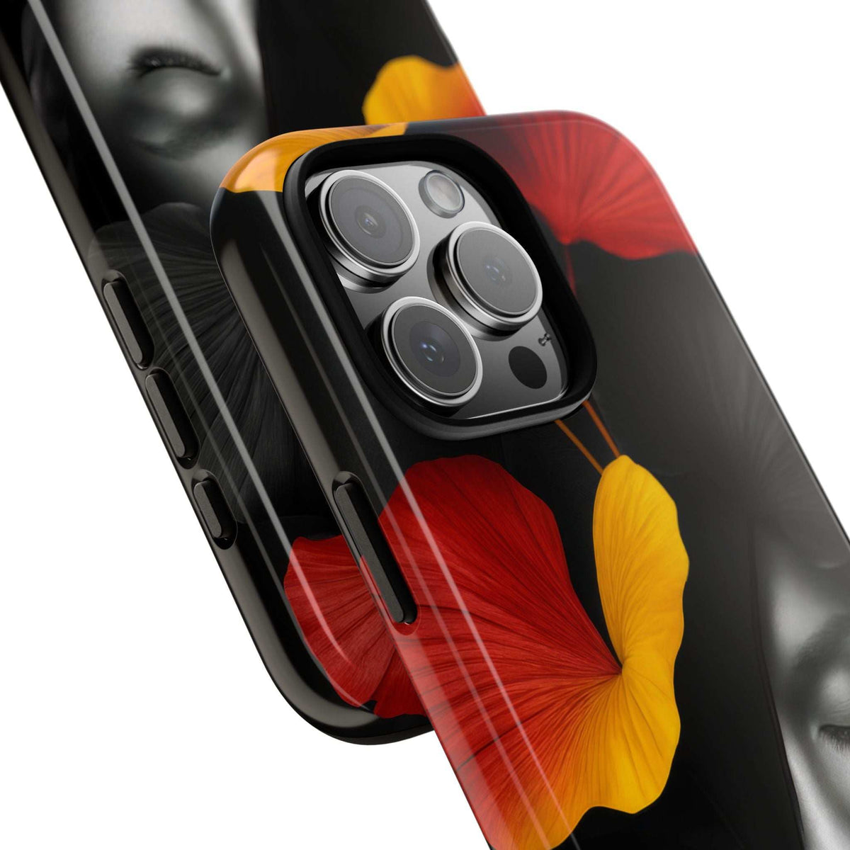 Glossy phone case close-up with camera cutout and red/yellow flower woman-face artwork.