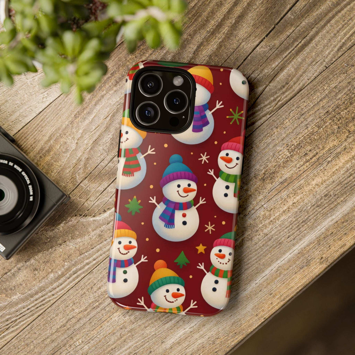 Glossy smartphone case with cute snowman pattern, smooth shell, and camera cutouts
