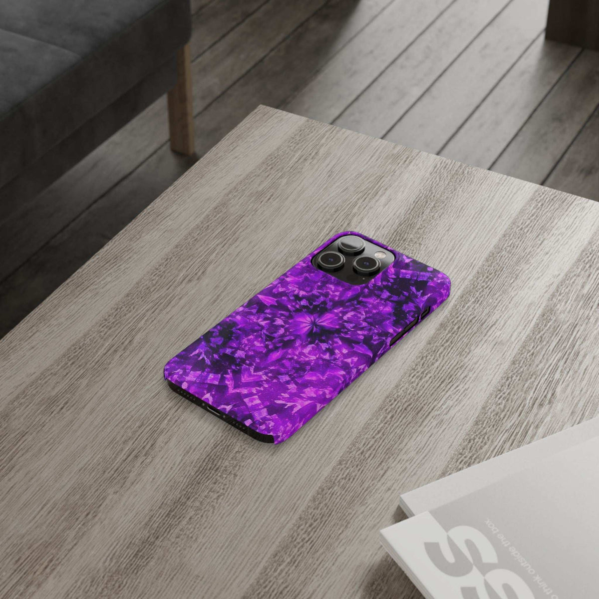 Purple kaleidoscope phone case with camera cutouts, glossy finish on a phone.