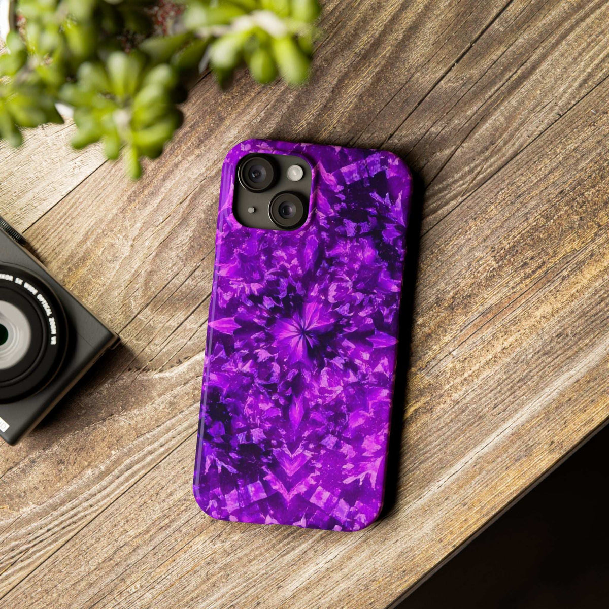 Purple kaleidoscope phone case on wood with triple camera cutouts and glossy finish.