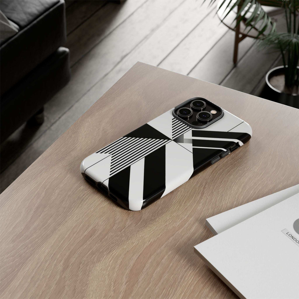Monochrome tough phone case with black-and-white geometric design on a phone