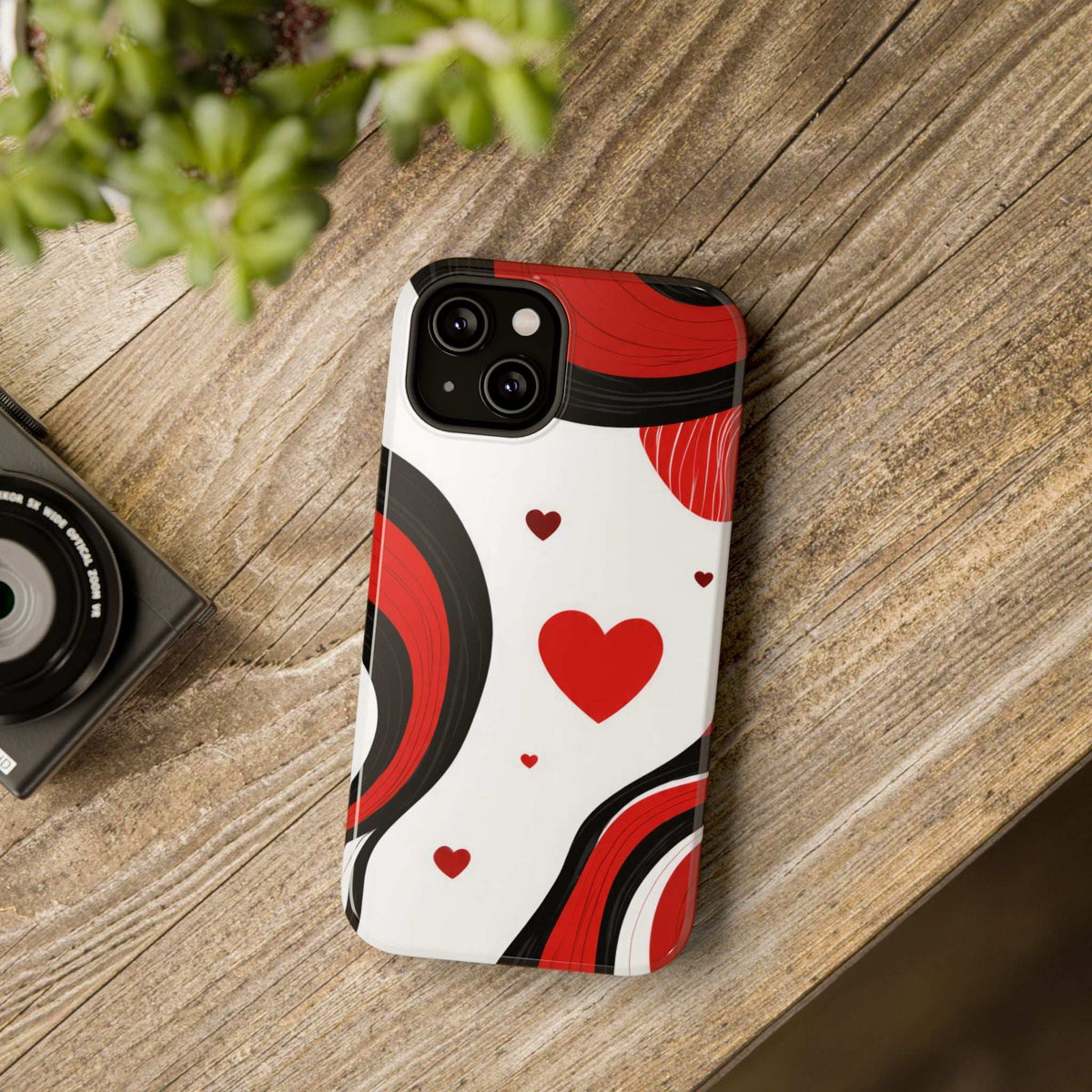 Glossy phone case showing red heart pattern on white background with black side bumpers