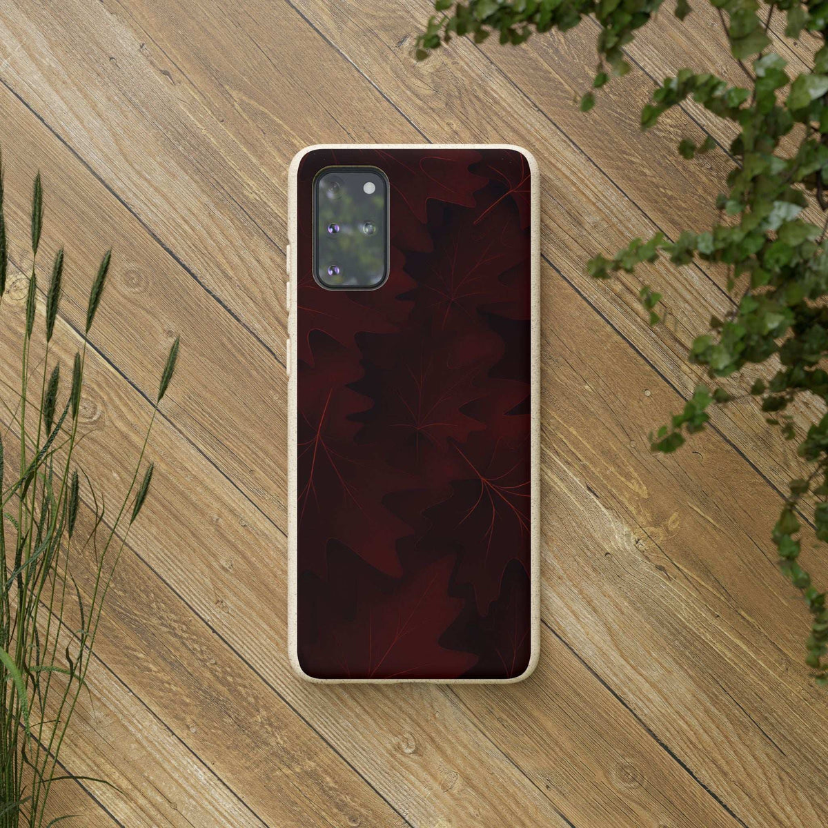 Phone case with burgundy leaf back and beige trim, camera cutout