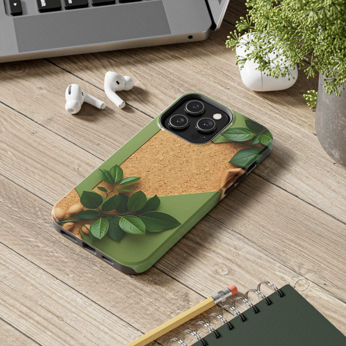 Green cork-look phone case with leaf design, camera lenses visible on the back