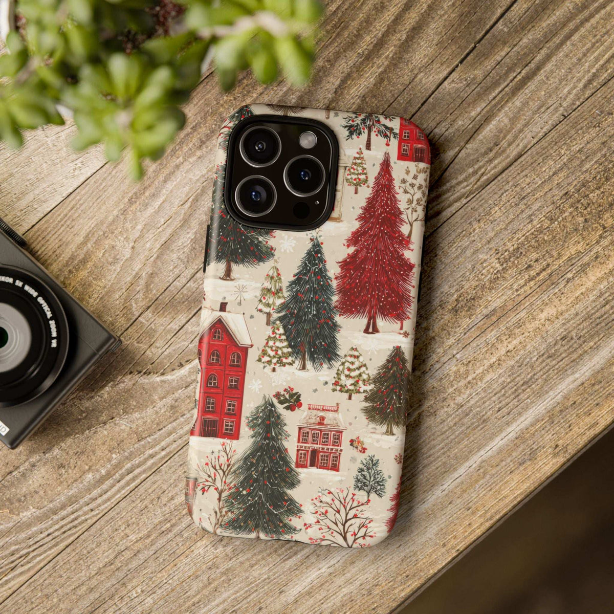 Winter village phone case featuring red houses and evergreen trees pattern