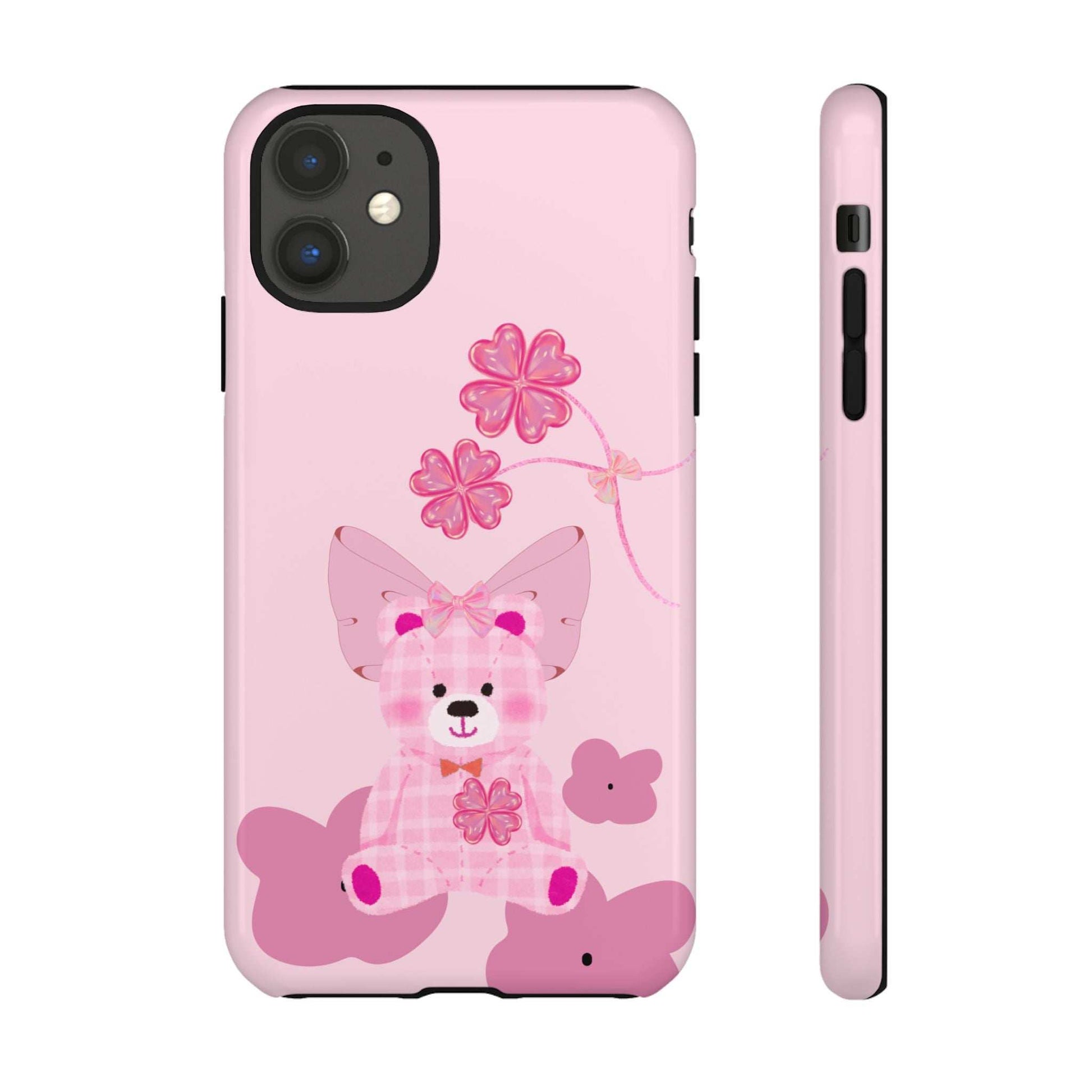 Pink phone case with teddy bear holding flowers; visible camera cutout and side buttons.