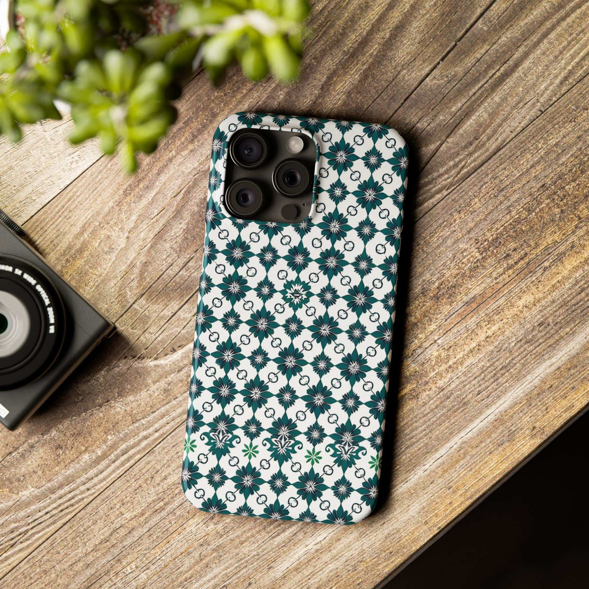 Geometric pattern phone case with teal and white floral design and camera cutouts