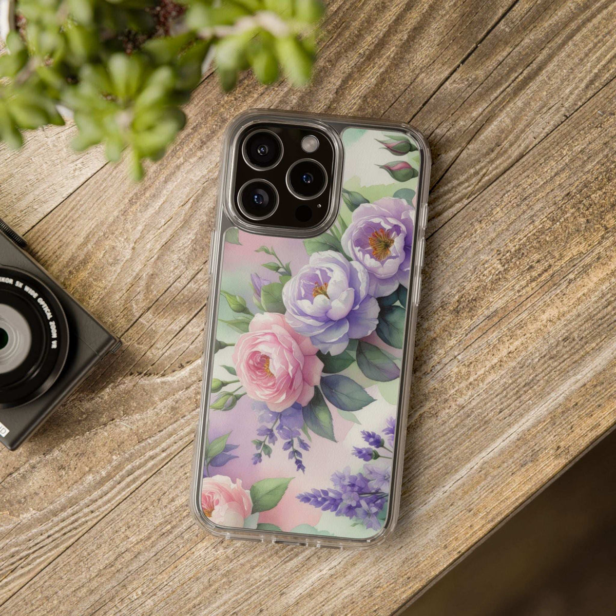 Clear floral phone case on a wood surface with pastel purple and pink flower design