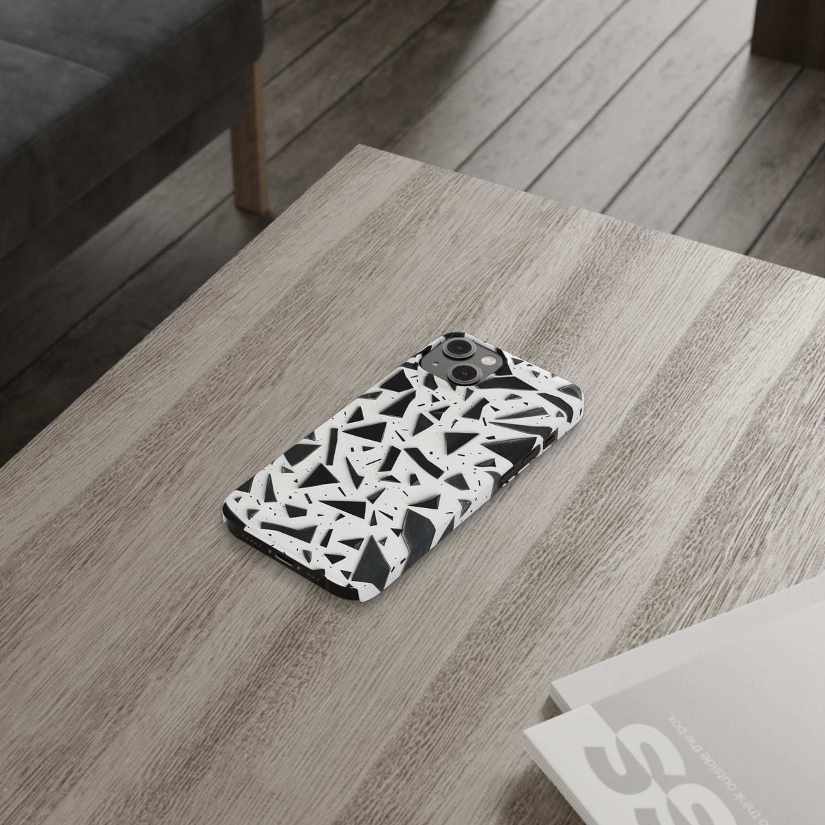 Slim iPhone phone case with white base and abstract black geometric pattern, camera cutouts.