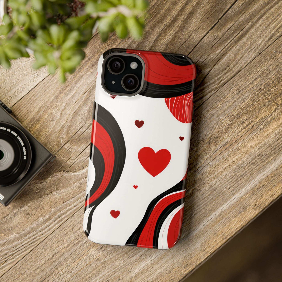 Glossy phone case on device with red hearts and red/black waves on white background