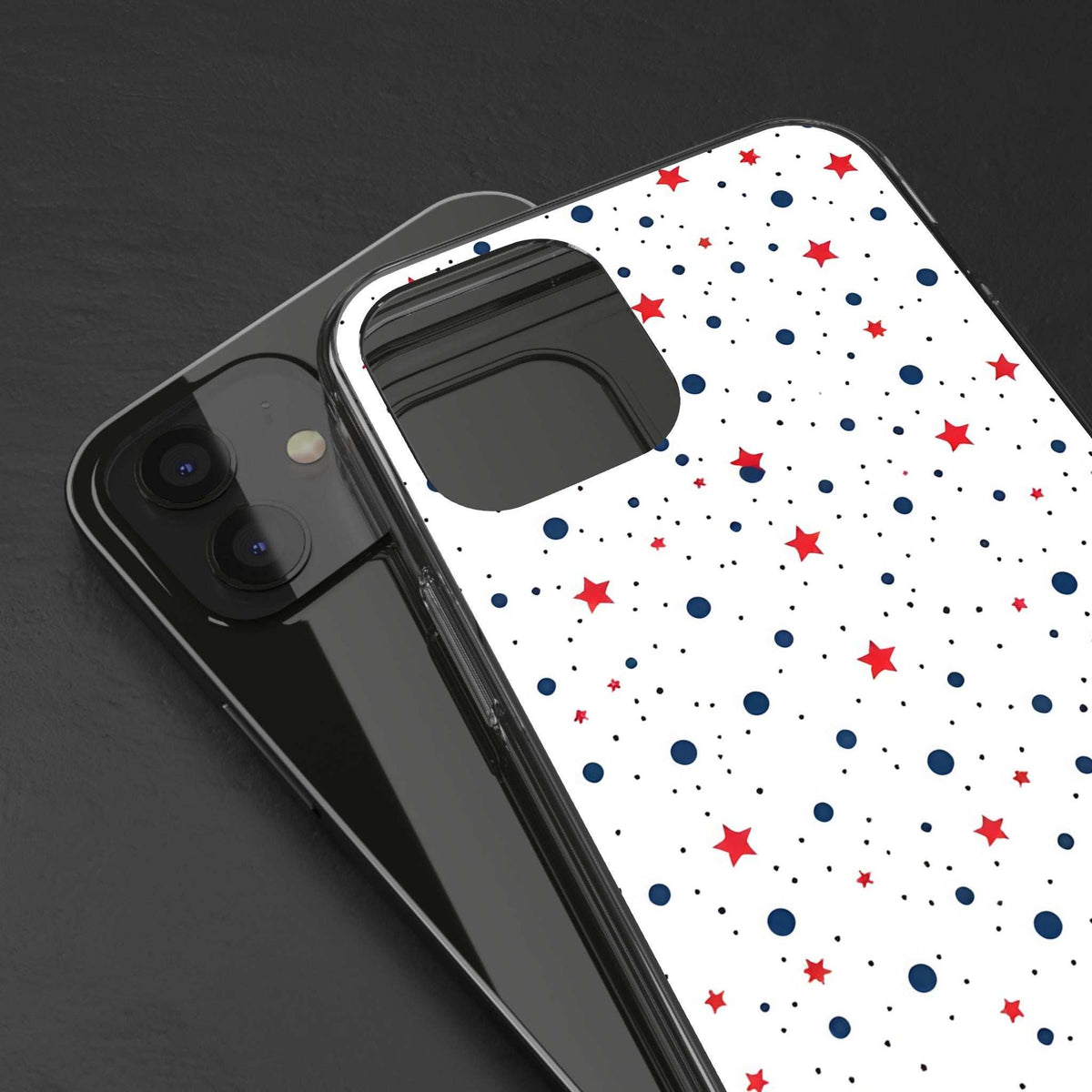 Clear phone case close-up showing white star and polka dot pattern and camera openings