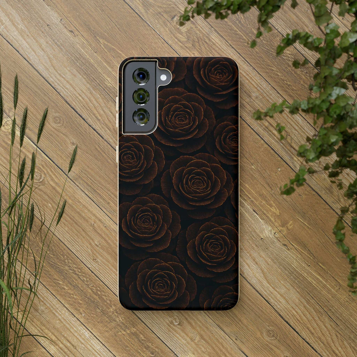 Dark phone case with rose pattern and three camera cutouts, speckled bumper