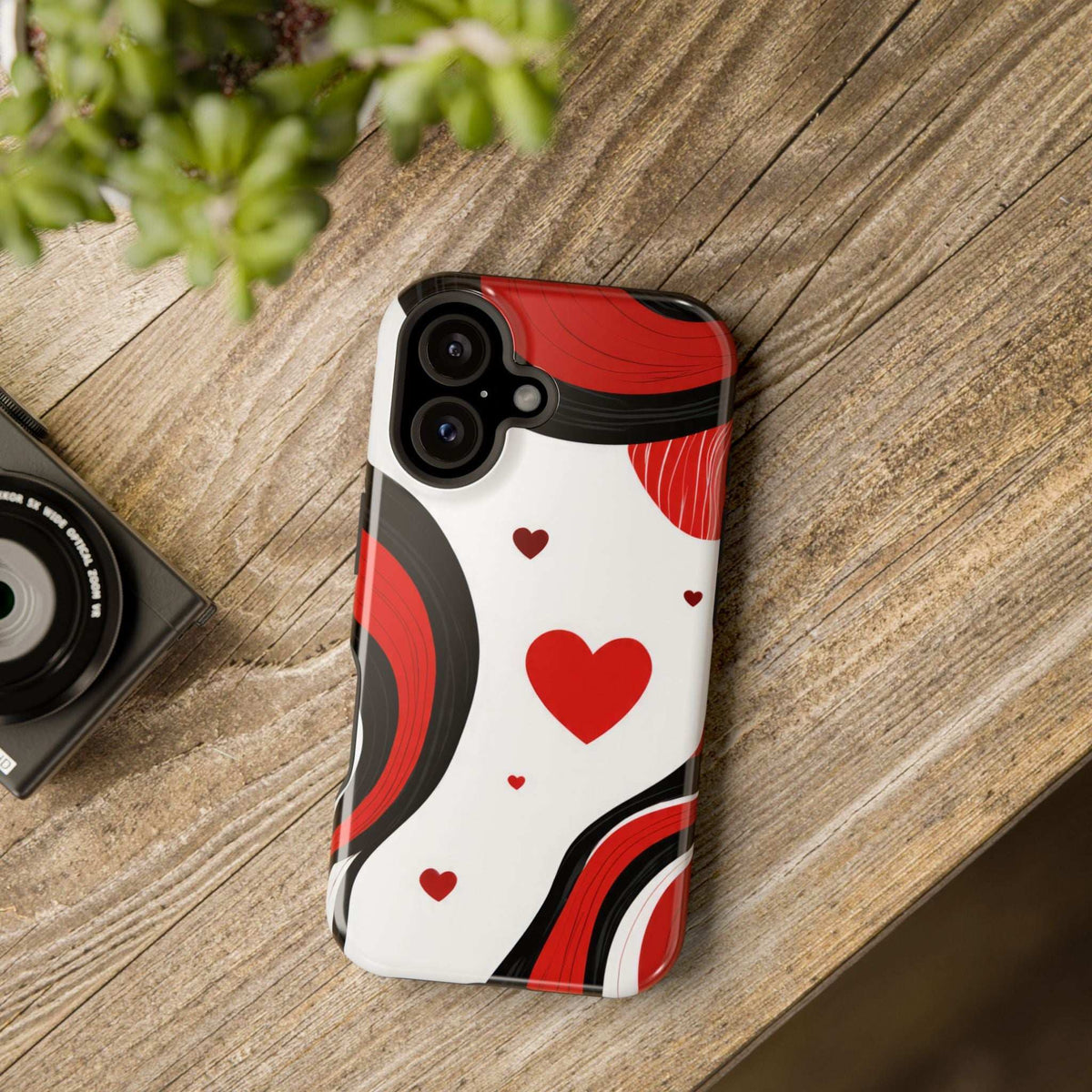 Phone case with red heart and wave swirl design on white background, camera cutouts