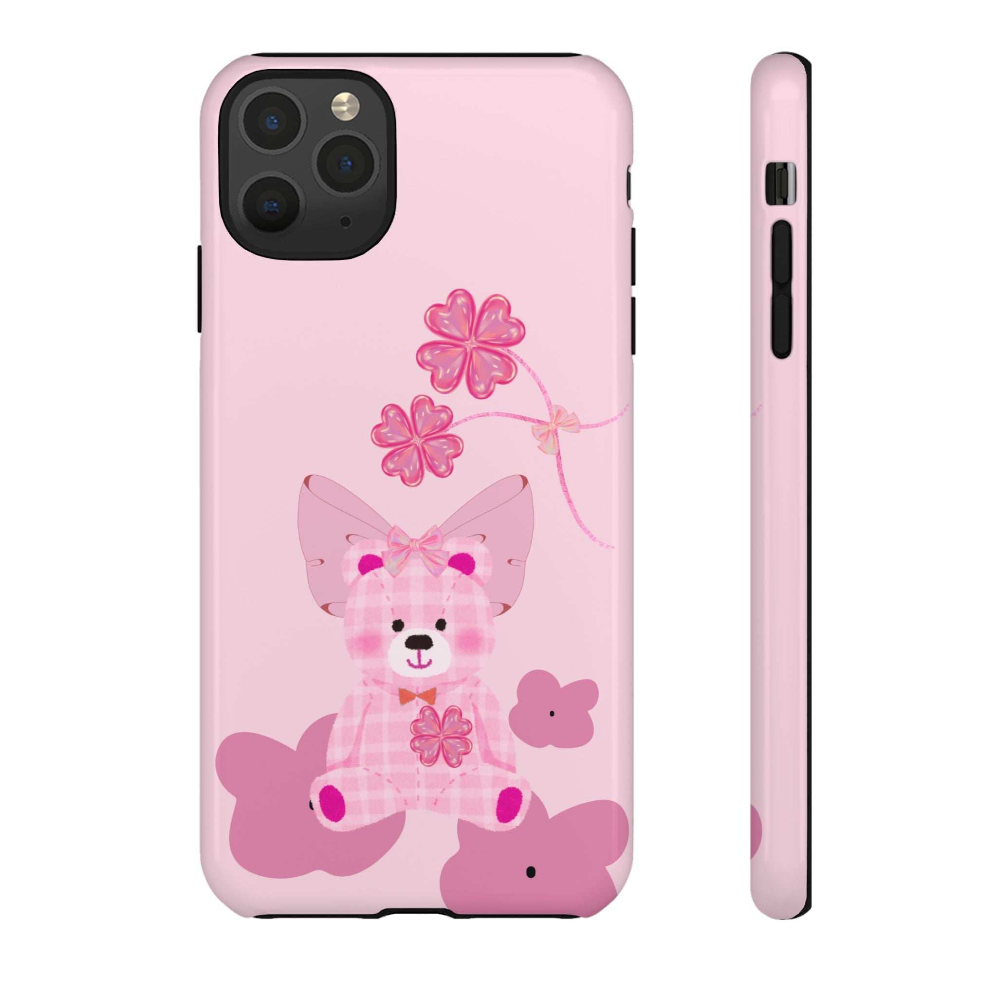 Pink phone case with teddy bear and bow; camera cutout and side buttons visible.