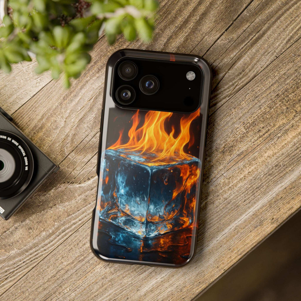 Flame and ice phone case on wood surface with orange flames over dark blue cube graphic