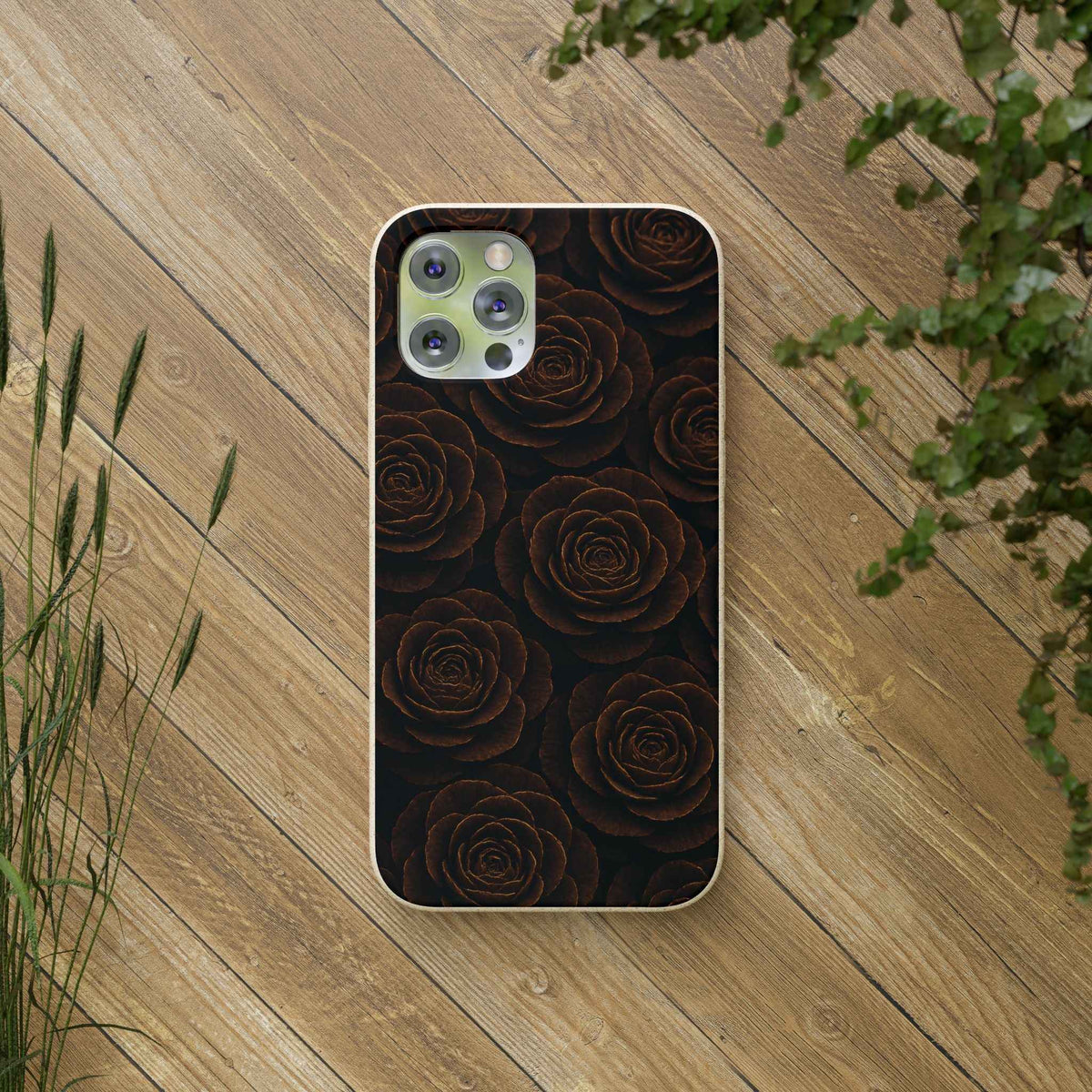 Dark rose patterned phone case with light wood trim, shown on wooden surface