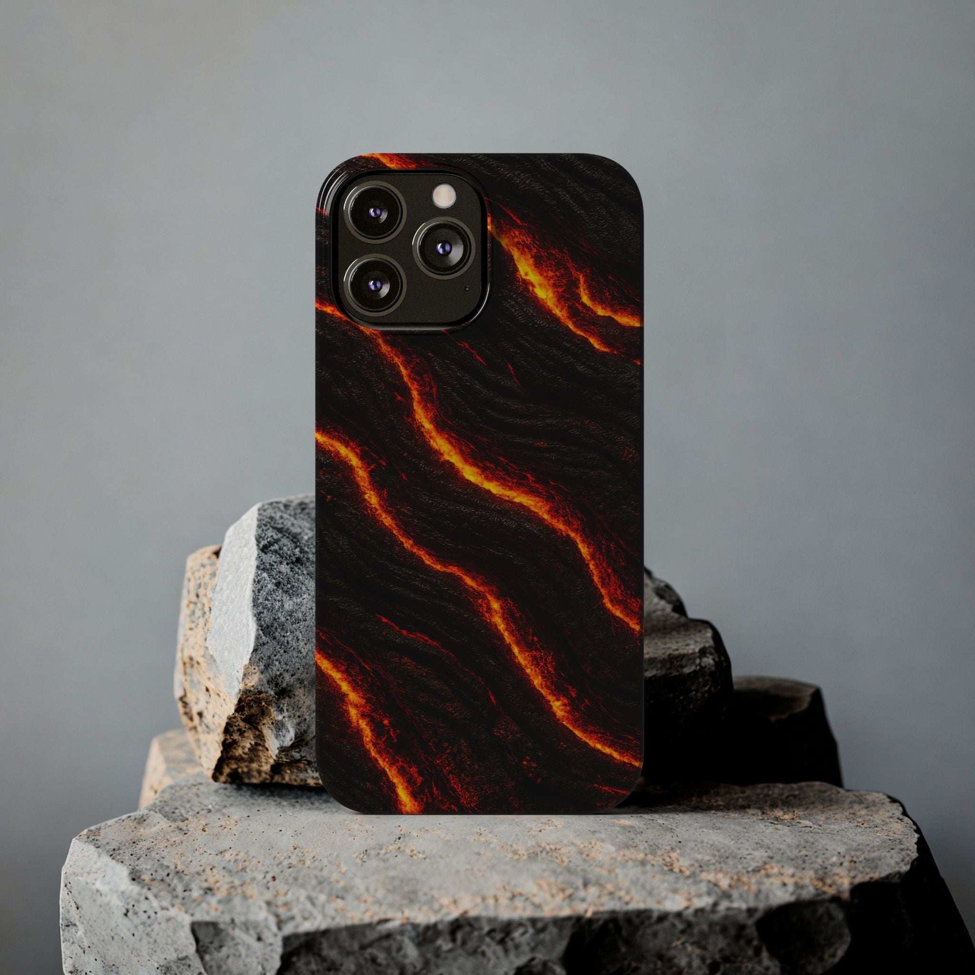 Black lava-pattern phone case on stone pedestal, orange-red glowing wave lines