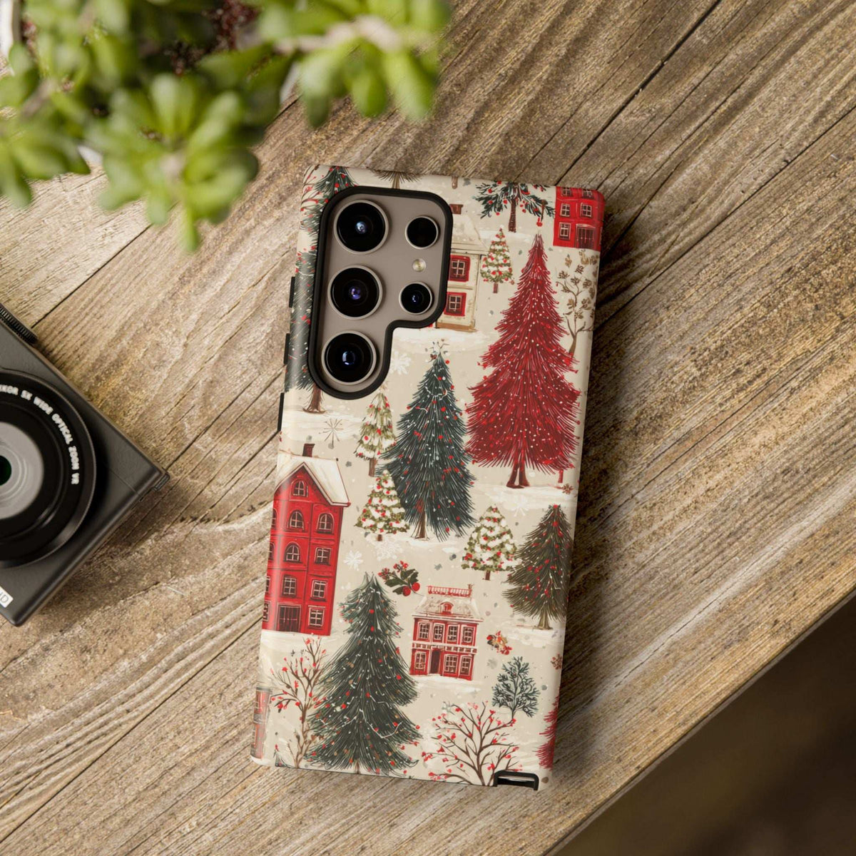 Winter village phone case with red houses and evergreen trees, camera cutouts