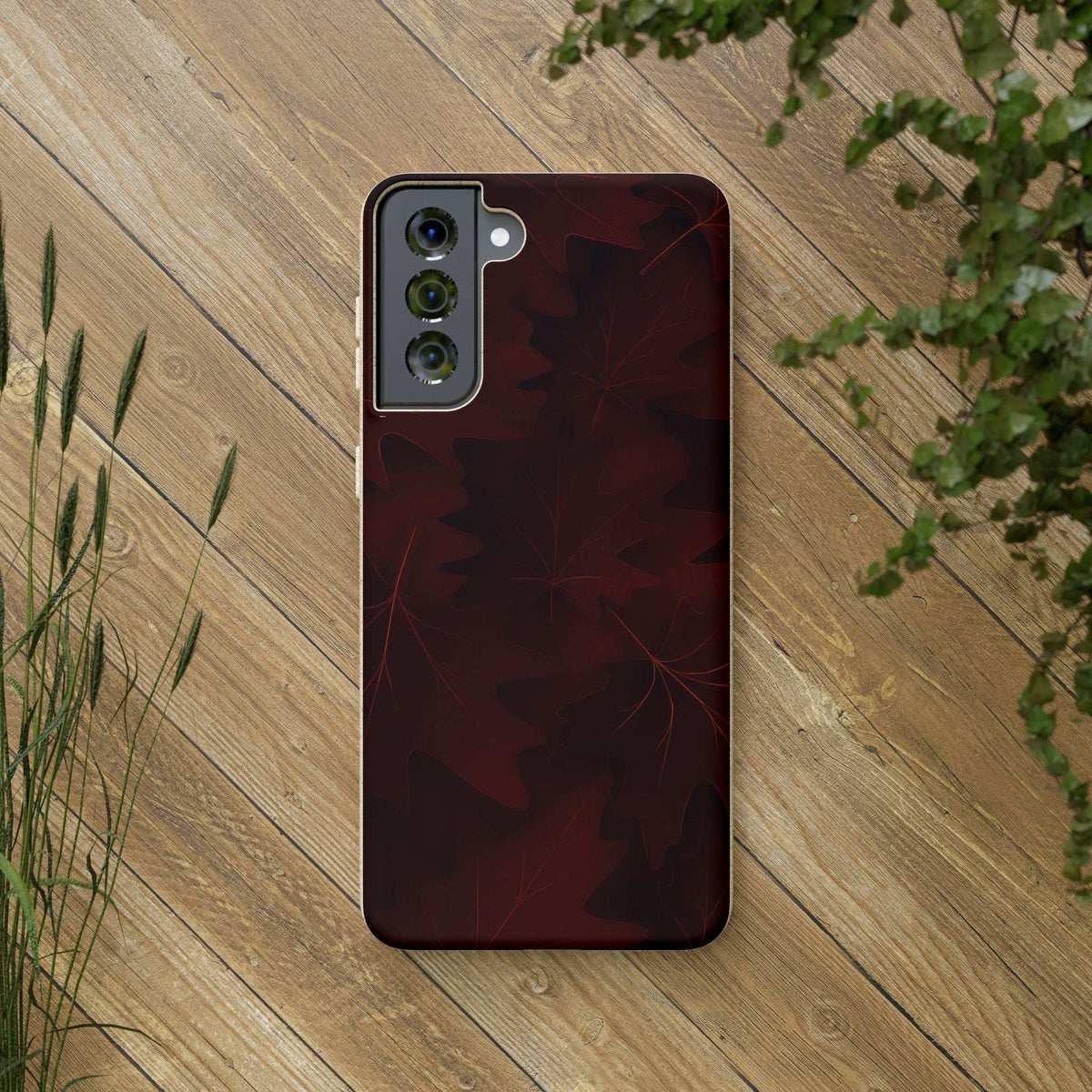 Burgundy phone case with leaf pattern and triple-camera cutout