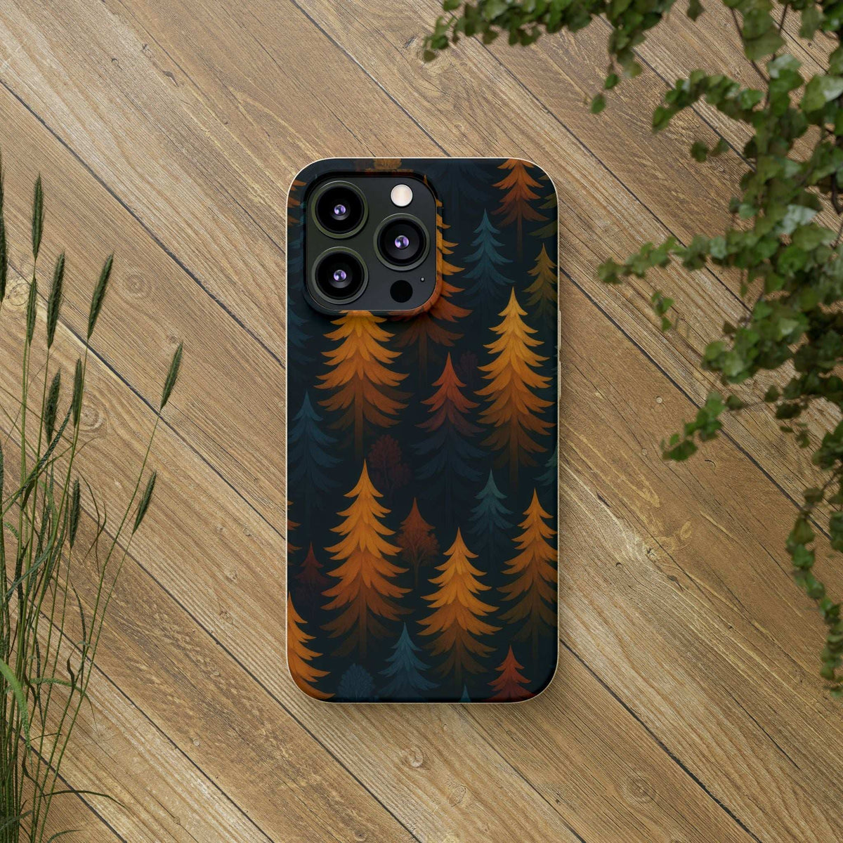 Biodegradable phone case with forest tree pattern, dark blue and orange leaves, back view