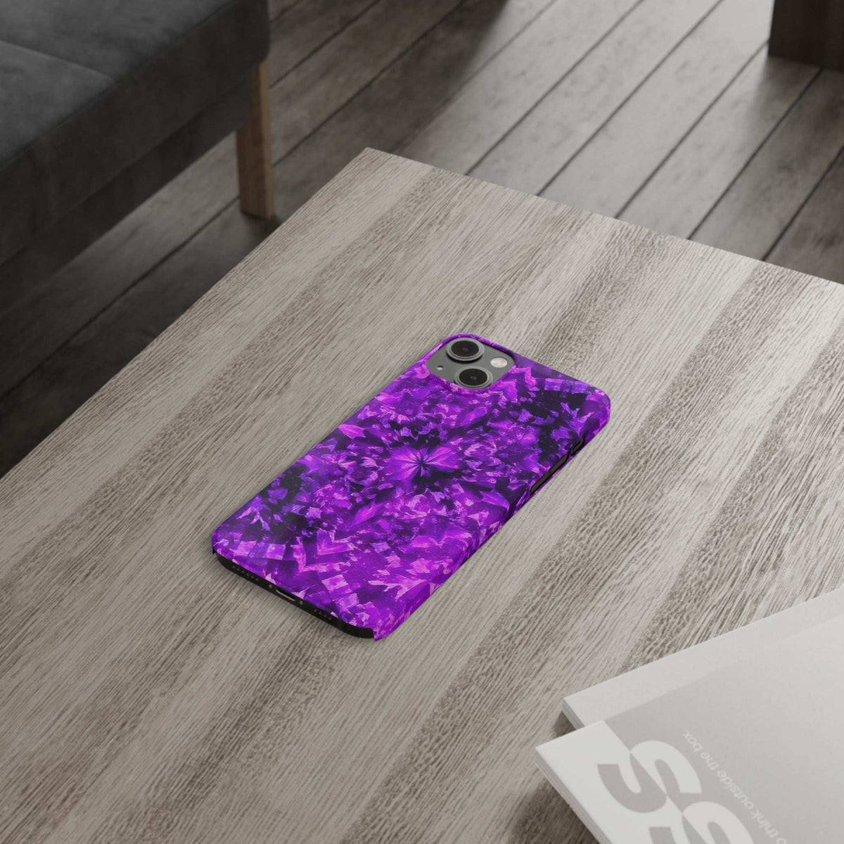 Purple kaleidoscope phone case viewed from above, showing rear camera cutouts.