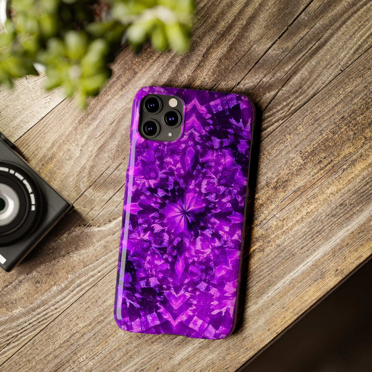 Purple kaleidoscope phone case with centered burst pattern and camera cutouts