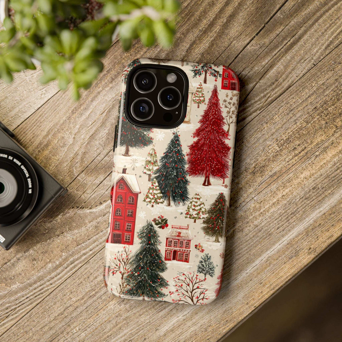 Winter village phone case with red houses and tall evergreen trees design