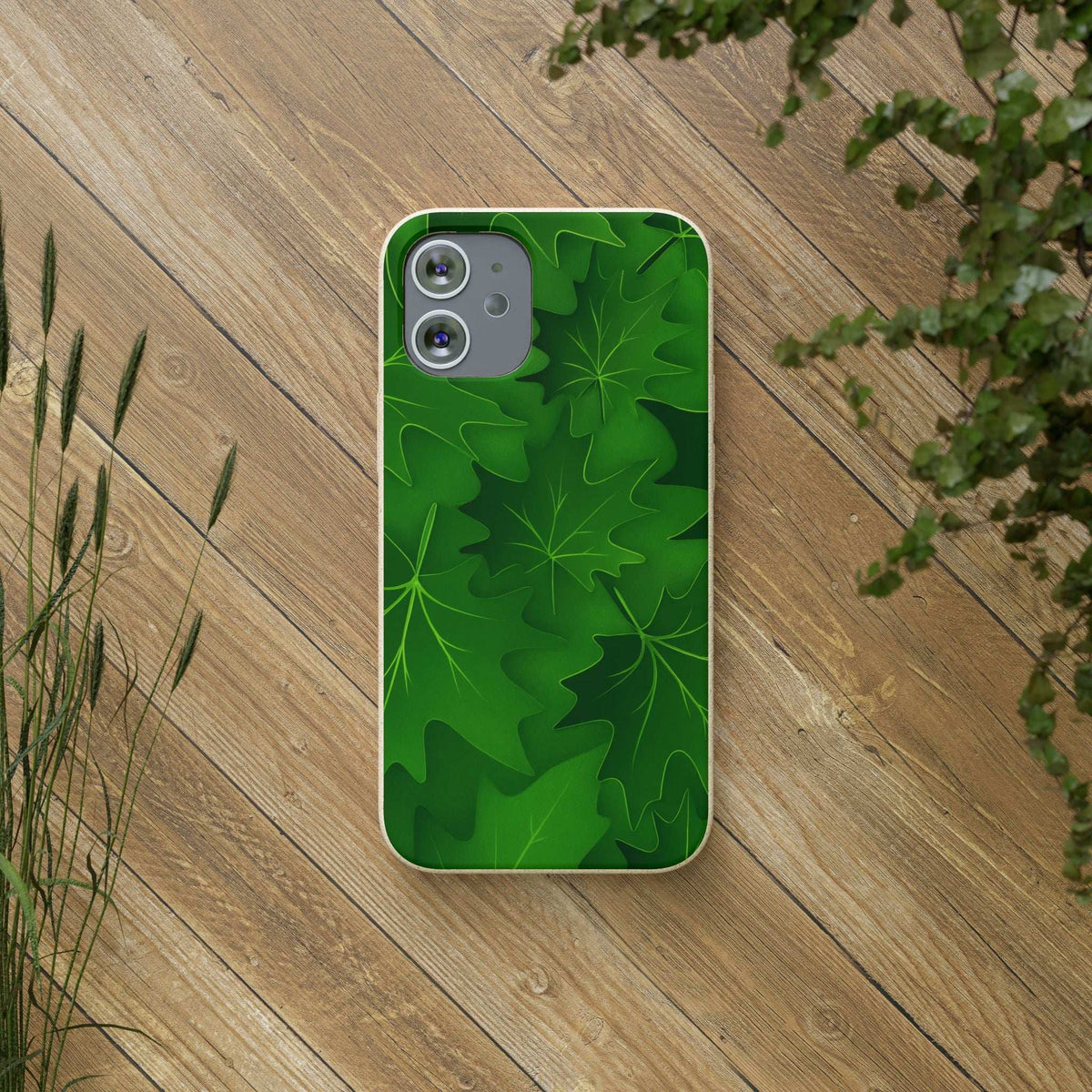 Green botanical leaf phone case on wooden surface with camera cutout